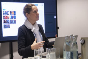 Eine Frau vor einem großen Monitor