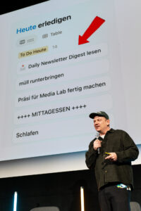 Man with cap and microphone standing on a stage